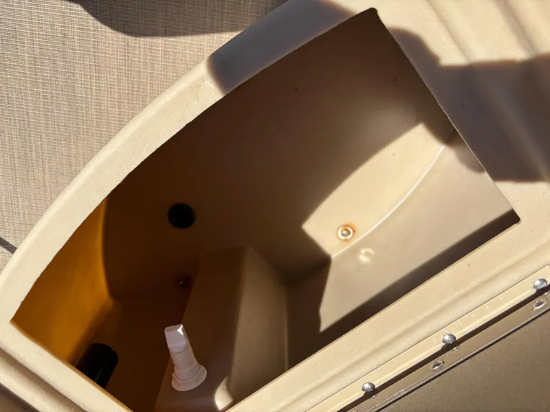 Slide: The Image of Storage compartment on a 2018 Bennington 21 SFX boat, featuring beige interior. - 7