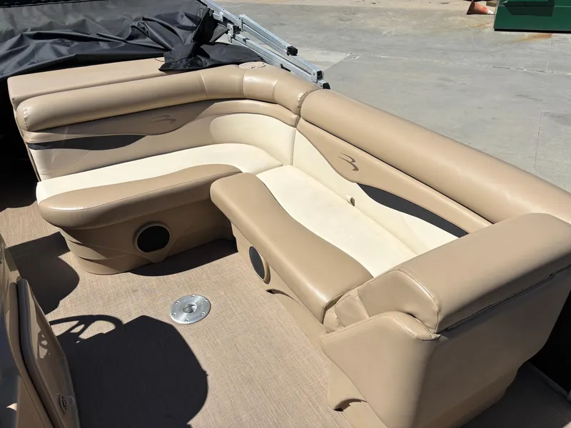 Slide: The Image of 2018 Bennington 21 SFX boat interior with beige seating and carpeted floor. - 9