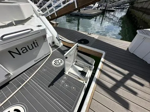 Slide: The Image of 2018 Cruisers Yachts 42 Cantius docked, featuring sleek deck design and marina setting. - 27