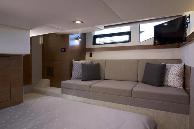 Slide: The Image of Interior of 2018 Cruisers Yachts 42 Cantius with sofa, TV, and modern decor. - 45