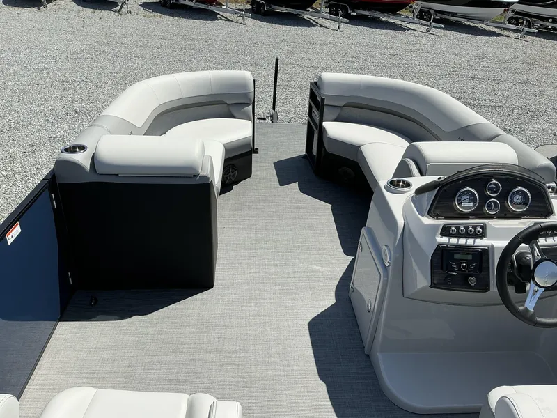 Slide: The Image of 2025 Lowe SS230 pontoon boat interior with plush seating and modern dashboard. - 11