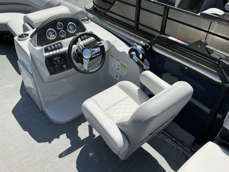 Slide: The Image of 2025 Lowe SS230 boat helm with modern steering wheel and control panel. - 12