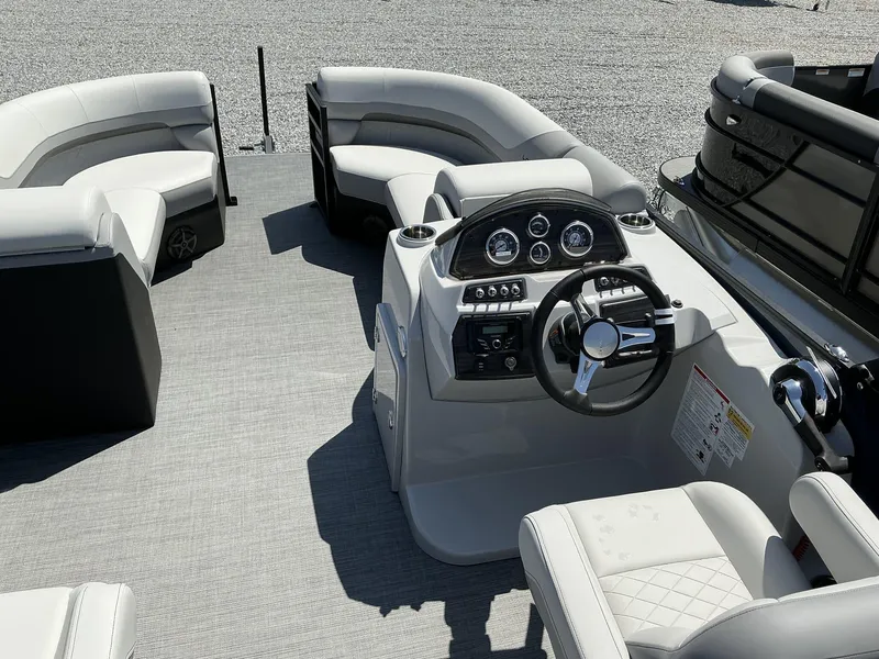 Slide: The Image of 2025 Lowe SS230 pontoon boat interior with modern helm and plush seating. - 13