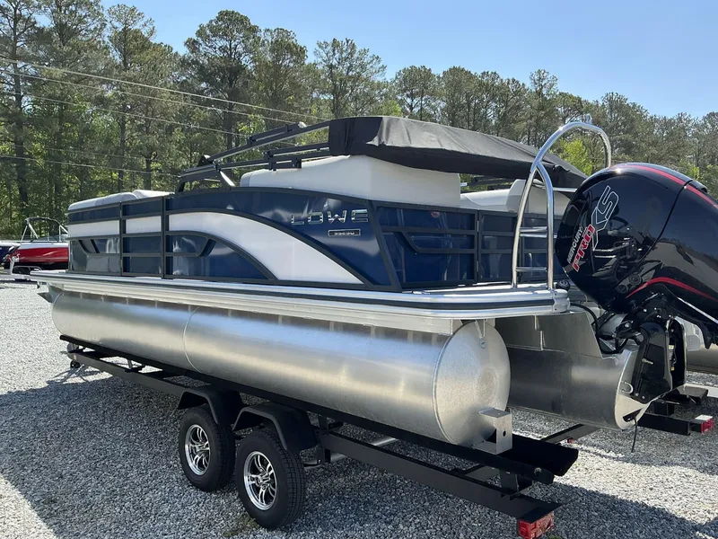 Slide: The Image of 2025 Lowe SS230 pontoon boat with outboard motor on a trailer. - 3