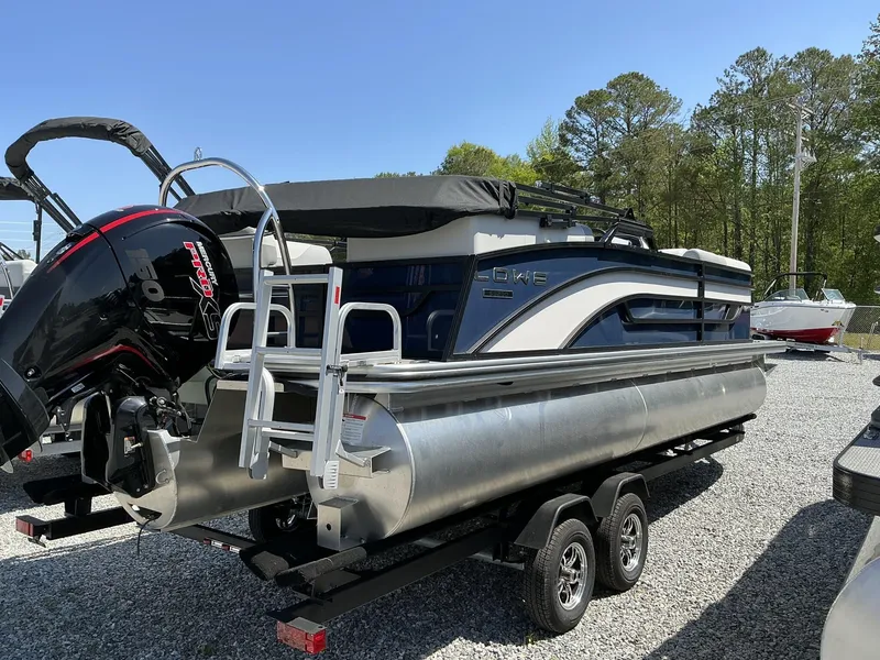 Slide: The Image of 2025 Lowe SS230 pontoon boat with Mercury outboard motor on a trailer. - 4