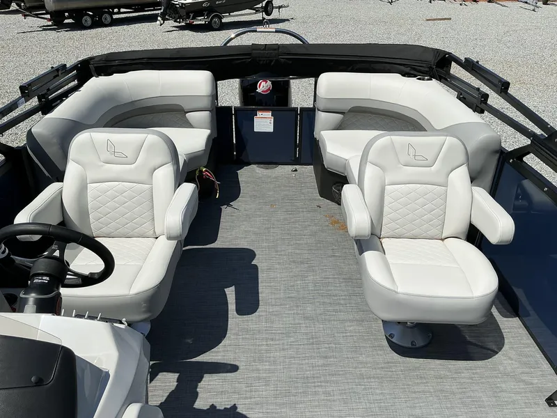 Slide: The Image of 2025 Lowe SS230 boat interior with white cushioned seating and steering wheel. - 8