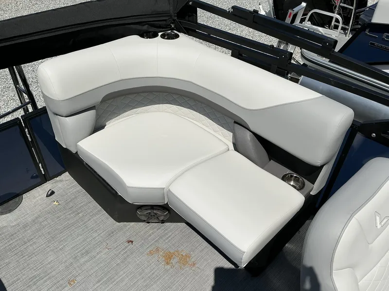 Slide: The Image of Luxurious seating on 2025 Lowe SS230 boat with white upholstery and cup holders. - 9