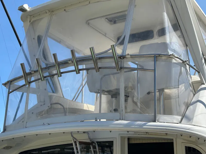 Slide: The Image of 1995 Ocean Yachts 42 Super Sport flybridge with clear enclosure and rod holders. - 10