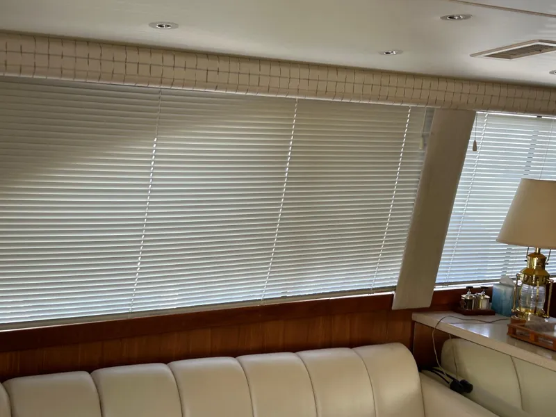 Slide: The Image of Interior of a 1995 Ocean Yachts 42 Super Sport with blinds and a white leather sofa. - 13