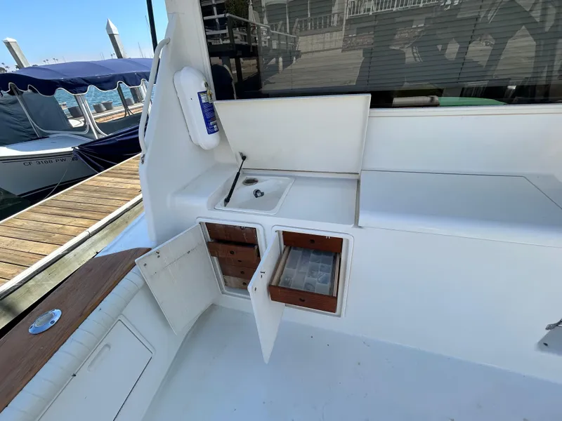 Slide: The Image of Ocean Yachts 42 Super Sport 1995 boat deck with storage compartments and sink. - 15