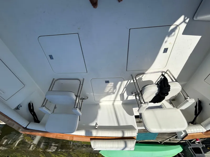 Slide: The Image of 1995 Ocean Yachts 42 Super Sport deck with white seating and storage compartments. - 23