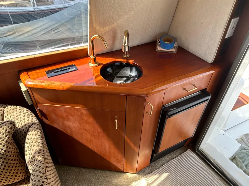 Slide: The Image of Luxurious 1995 Ocean Yachts 42 Super Sport interior with sink and mini fridge. - 24