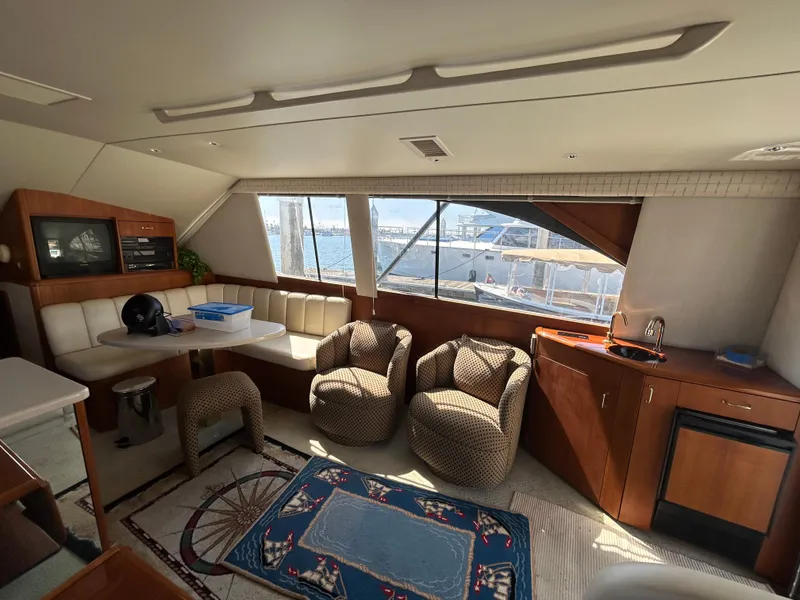 Slide: The Image of Interior of a 1995 Ocean Yachts 42 Super Sport, featuring seating and kitchenette. - 30