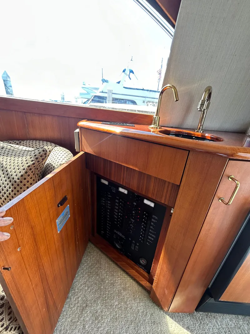 Slide: The Image of Interior of 1995 Ocean Yachts 42 Super Sport with wooden cabinetry and sink. - 32