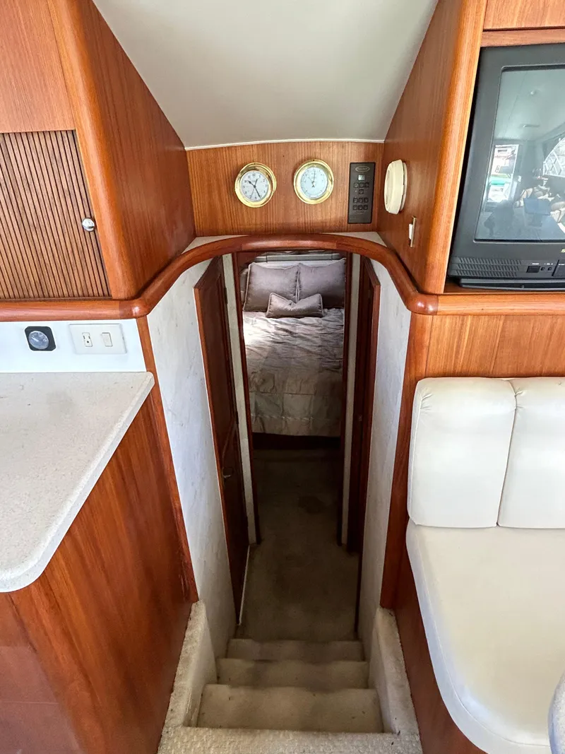 Slide: The Image of Interior view of 1995 Ocean Yachts 42 Super Sport, featuring wood paneling and cozy cabin. - 38