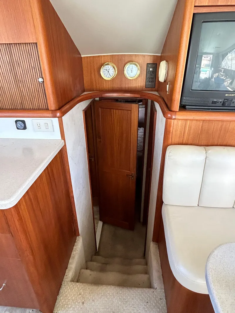 Slide: The Image of Interior of 1995 Ocean Yachts 42 Super Sport with wooden cabinetry and stairs. - 39
