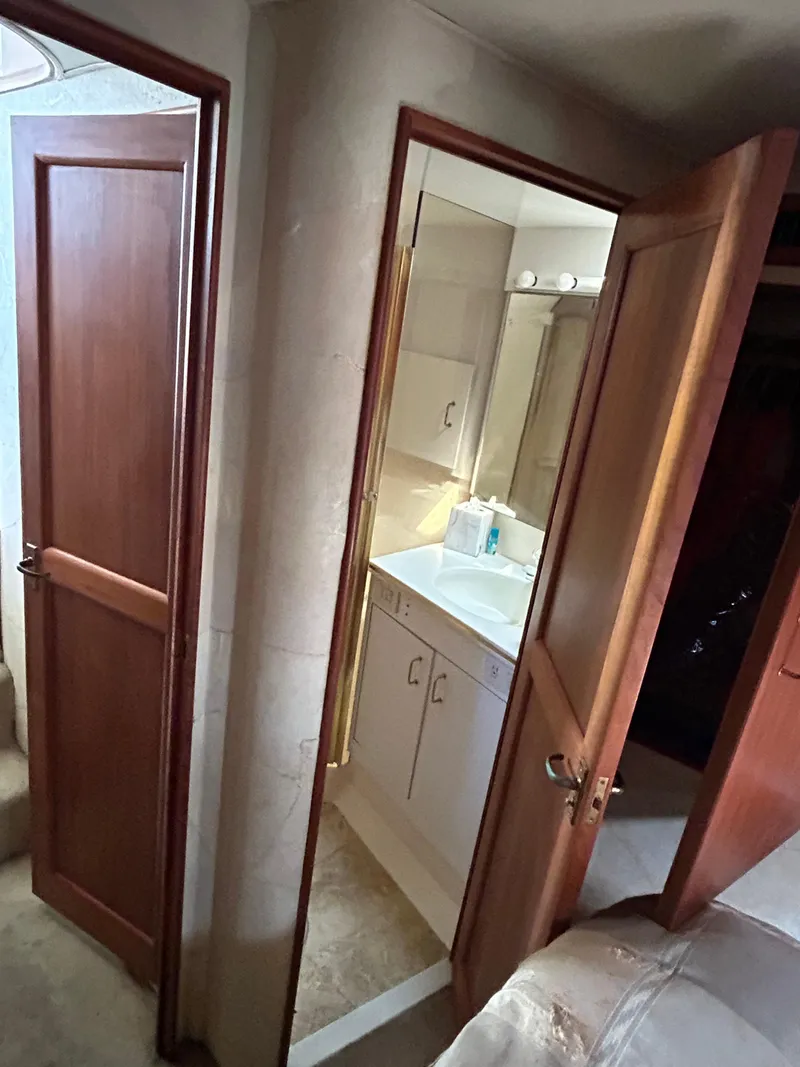 Slide: The Image of Bathroom interior of 1995 Ocean Yachts 42 Super Sport with wooden doors and vanity. - 41