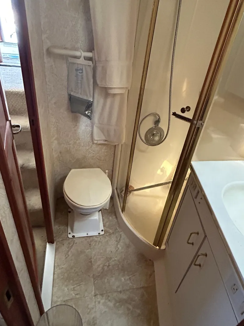 Slide: The Image of Bathroom in 1995 Ocean Yachts 42 Super Sport with shower, toilet, and sink. - 42