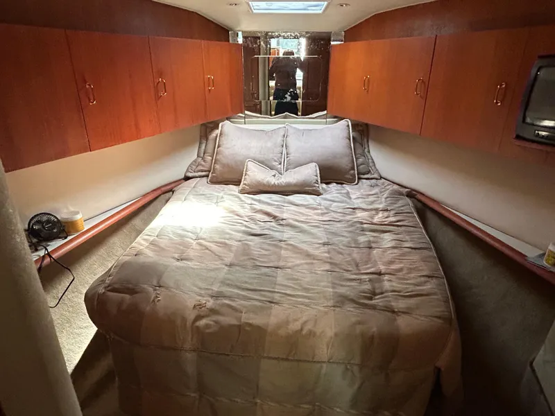 Slide: The Image of Luxurious cabin interior of 1995 Ocean Yachts 42 Super Sport with cozy bed and wooden cabinets. - 43