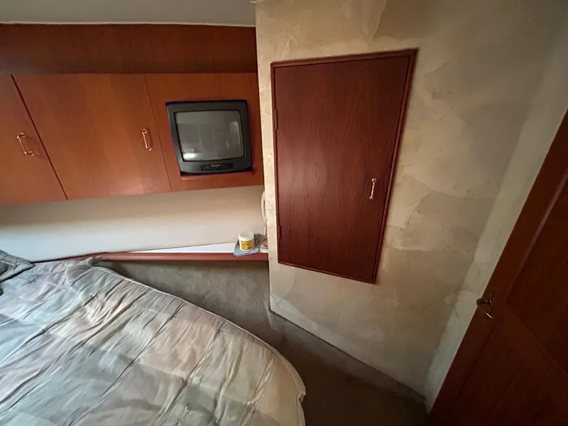 Slide: The Image of Bedroom interior of 1995 Ocean Yachts 42 Super Sport with TV and wooden cabinets. - 44