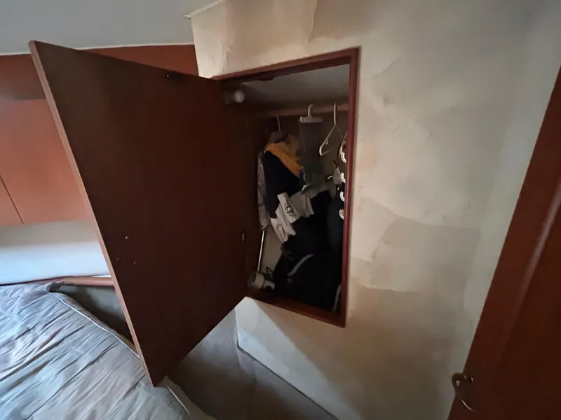 Slide: The Image of Open closet in 1995 Ocean Yachts 42 Super Sport, showing hanging clothes. - 46