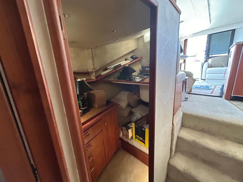 Slide: The Image of Interior view of 1995 Ocean Yachts 42 Super Sport, featuring storage area and steps to living space. - 47