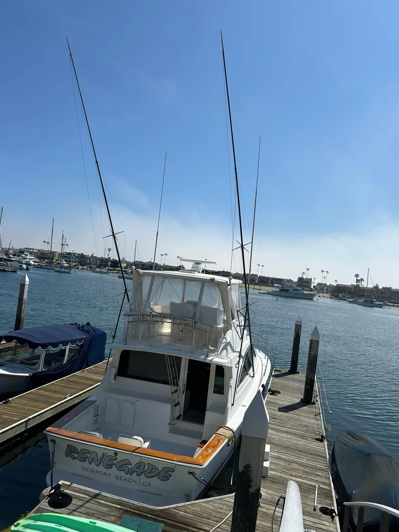 Slide: The Image of 1995 Ocean Yachts 42 Super Sport docked at marina under clear blue sky. - 7