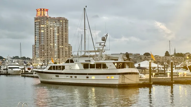 The Image of Luxury yacht "Burger 86 Raised Pilothouse" docked at marina, cityscape in background, 1987 model. - 0