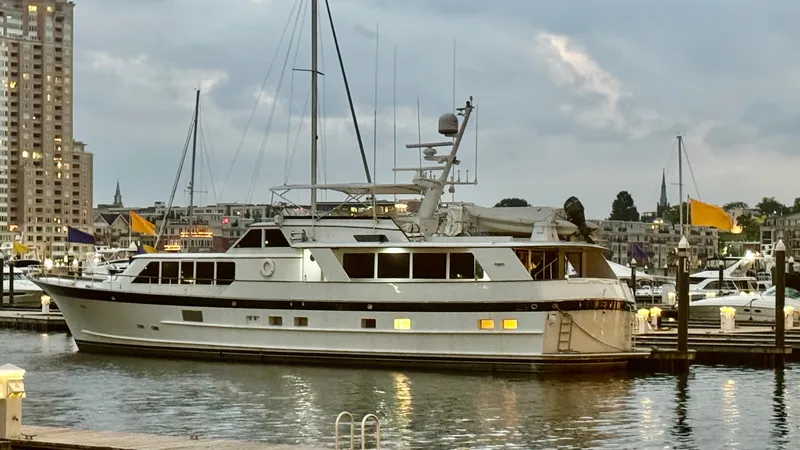 Slide: The Image of Luxury yacht docked at marina, Burger 86 Raised Pilothouse, 1987 model, evening setting. - 1