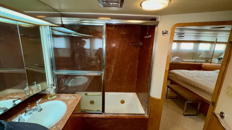 Slide: The Image of Luxurious bathroom in 1987 Burger 86 Raised Pilothouse yacht with marble accents and spacious layout. - 13