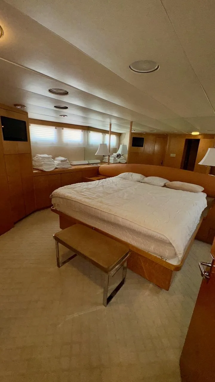 Slide: The Image of Luxurious bedroom interior of 1987 Burger 86 Raised Pilothouse yacht with elegant wood paneling. - 15