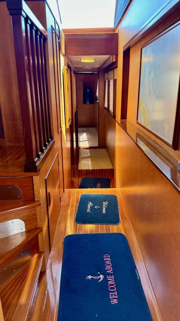 Slide: The Image of Interior hallway of 1987 Burger 86 Raised Pilothouse yacht with wooden finishes. - 16