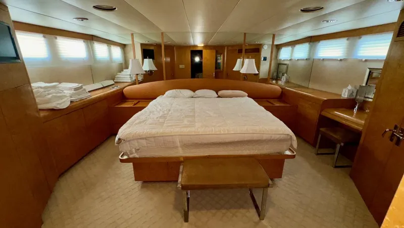 Slide: The Image of Luxurious bedroom in 1987 Burger 86 Raised Pilothouse yacht with elegant wood finishes. - 19