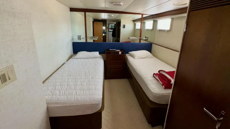 Slide: The Image of Twin beds in a cozy cabin aboard a 1987 Burger 86 Raised Pilothouse yacht. - 26