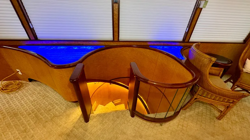 Slide: The Image of Luxurious interior of 1987 Burger 86 Raised Pilothouse yacht with elegant wood and blue lighting. - 31