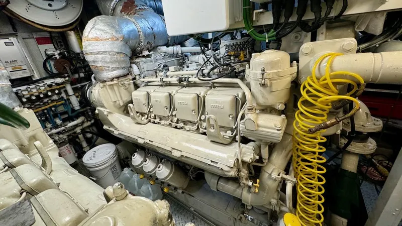 Slide: The Image of Engine room of 1987 Burger 86 Raised Pilothouse yacht, showcasing complex machinery and components. - 33