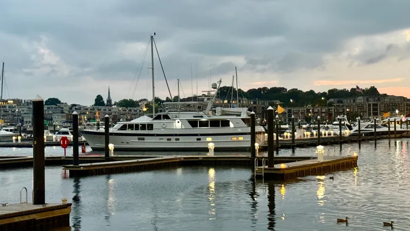 Slide: The Image of Luxury yacht "Burger 86 Raised Pilothouse" docked at marina, evening view, 1987 model. - 4
