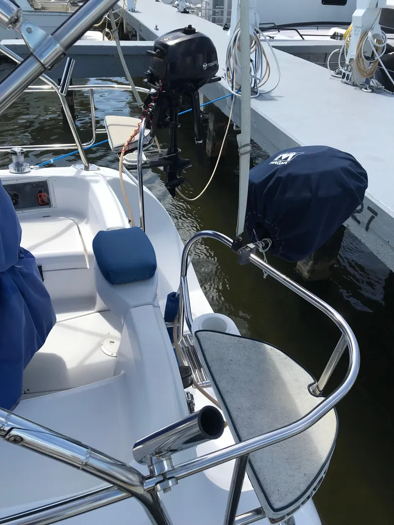 Slide: The Image of 2009 Hunter 310 sailboat cockpit with motor, docked at marina. - 10