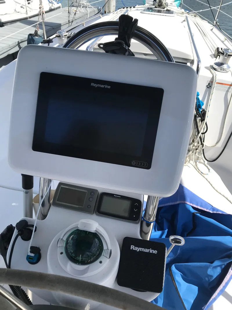 Slide: The Image of 2009 Hunter 310 sailboat cockpit with Raymarine navigation equipment. - 12