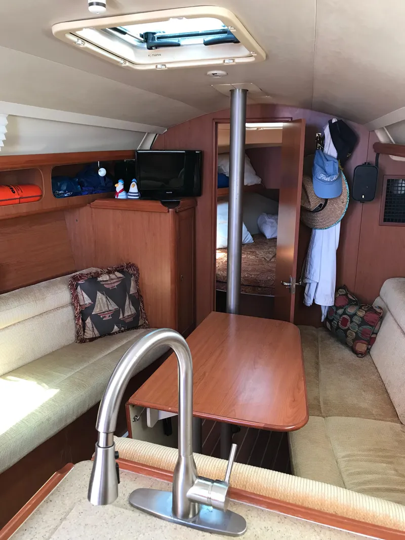 Slide: The Image of Interior of 2009 Hunter 310 sailboat with cozy seating and modern amenities. - 14