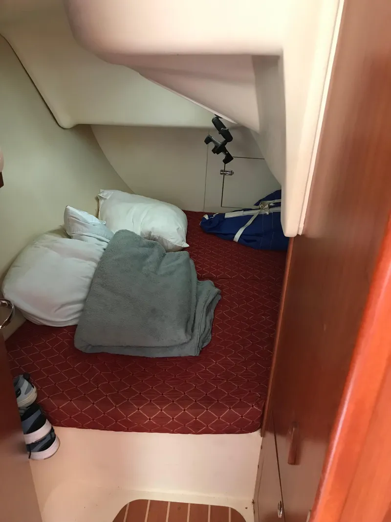 Slide: The Image of Cozy cabin interior of 2009 Hunter 310 sailboat with bed and pillows. - 20