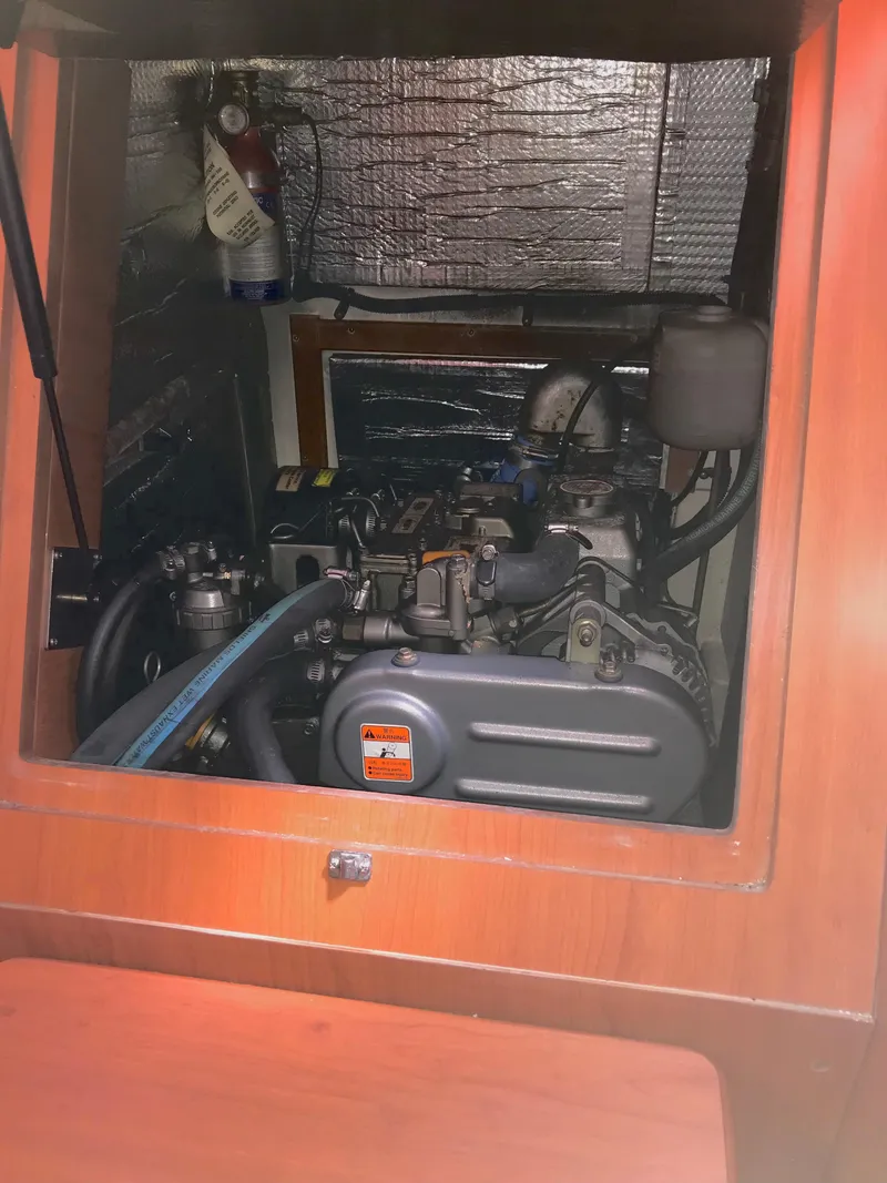 Slide: The Image of Engine compartment of a 2009 Hunter 310 sailboat, featuring visible mechanical components. - 22