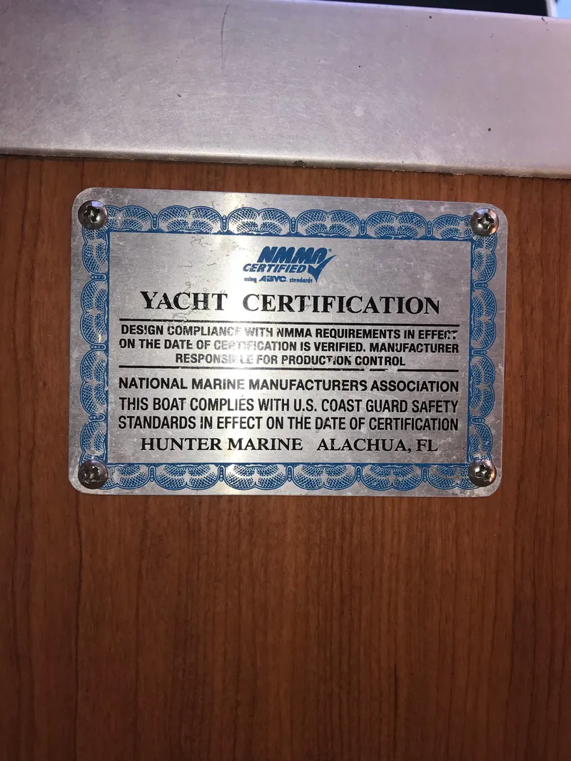 Slide: The Image of Yacht certification plaque for 2009 Hunter 310, verifying compliance with safety standards. - 25