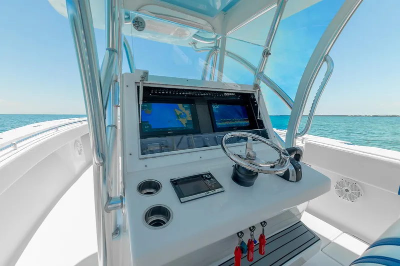 Slide: The Image of 2017 SeaHunter 35 Tournament boat cockpit with navigation screens and steering wheel. - 13