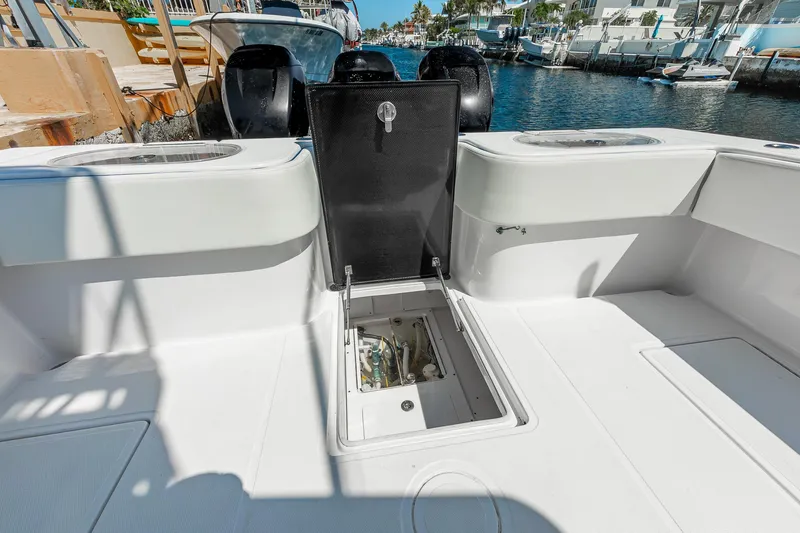 Slide: The Image of 2017 SeaHunter 35 Tournament boat deck with open storage compartment, docked by the water. - 19