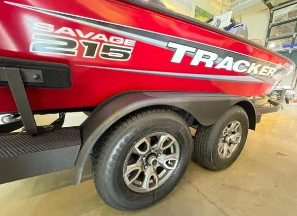 Slide: The Image of 2025 Tracker Savage 215 boat trailer with dual wheels in a garage setting. - 3