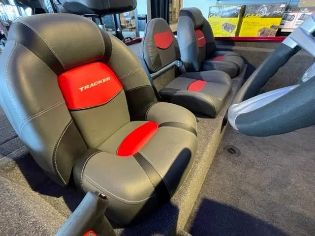 Slide: The Image of 2025 Tracker Savage 215 boat interior with black and red cushioned seats. - 5
