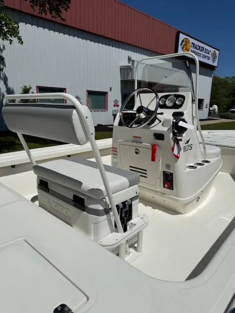 Slide: The Image of 2025 Mako 18 LTS boat interior with steering console and seating. - 10