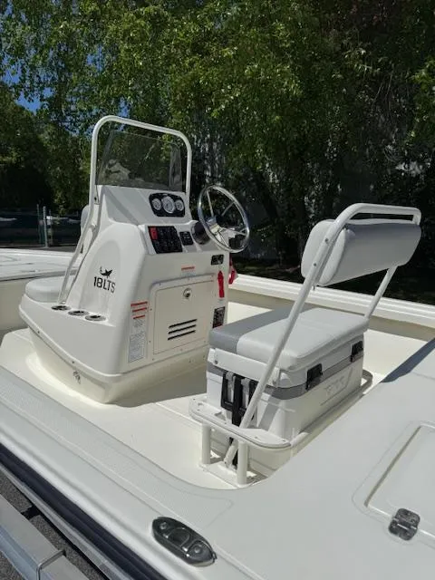 Slide: The Image of 2025 Mako 18 LTS boat interior with steering console and seating. - 11