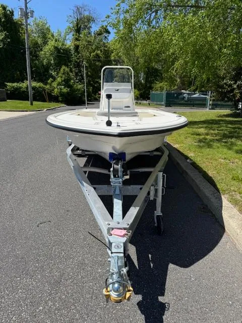 Slide: The Image of 2025 Mako 18 LTS boat on trailer, parked on a sunny street. - 5